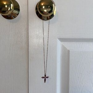 Beautiful Cross necklace with maroon gems and a gold(not real gold) chain.